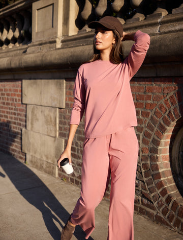 Lifestyle on-model shot of the Cloud Cotton Long Sleeve T-Shirt in Winter Rose paired with the Cloud Cotton Pant in Winter Rose.