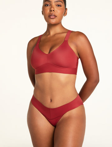 Three-quarter front view of the Bliss Low Rise Bikini in Ruby paired with the BlissSmooth Bralette in Ruby.