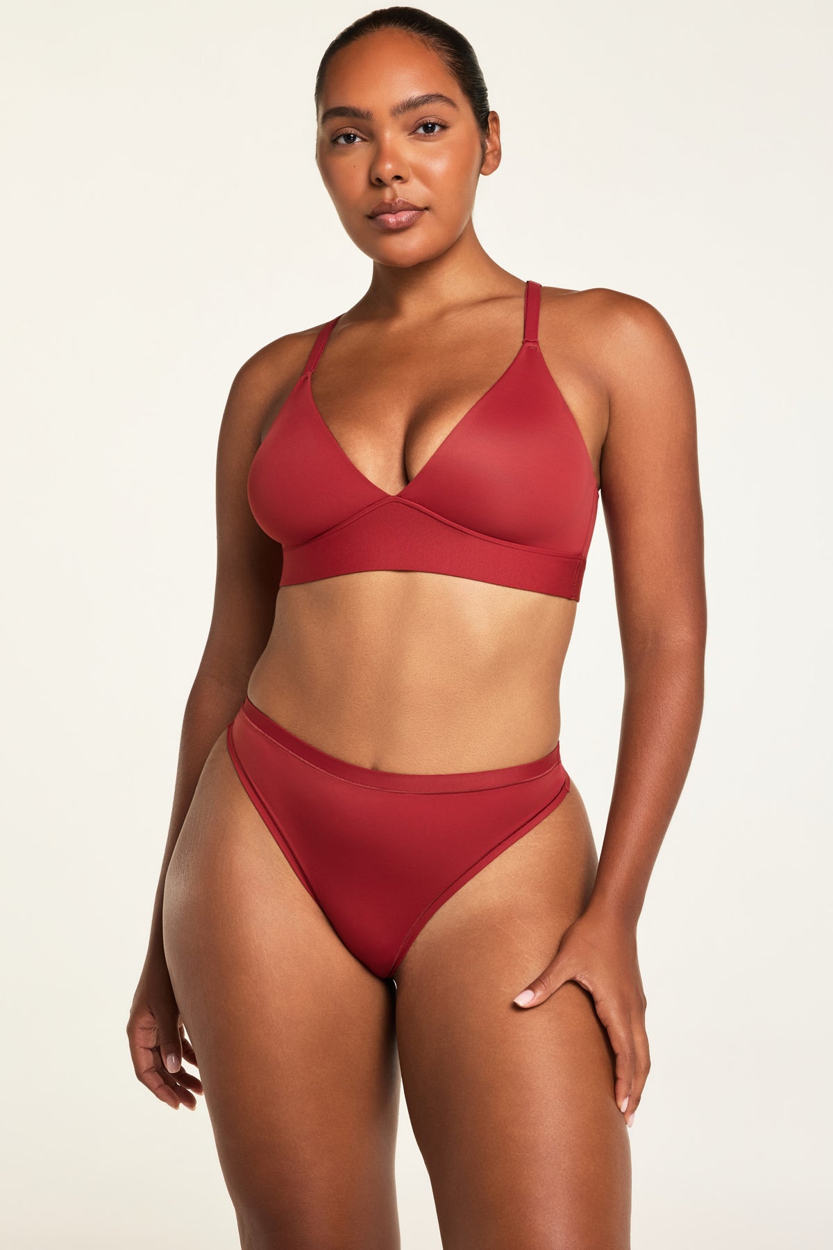 Three-quarter front view of the Bliss Thong in Ruby paired with the Bliss Triangle Bralette in Ruby.