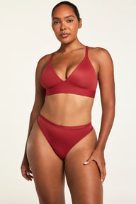 Three-quarter front view of the Bliss Thong in Ruby paired with the Bliss Triangle Bralette in Ruby.