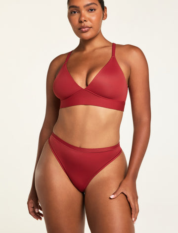 Three-quarter front view of the Bliss Thong in Ruby paired with the Bliss Triangle Bralette in Ruby.