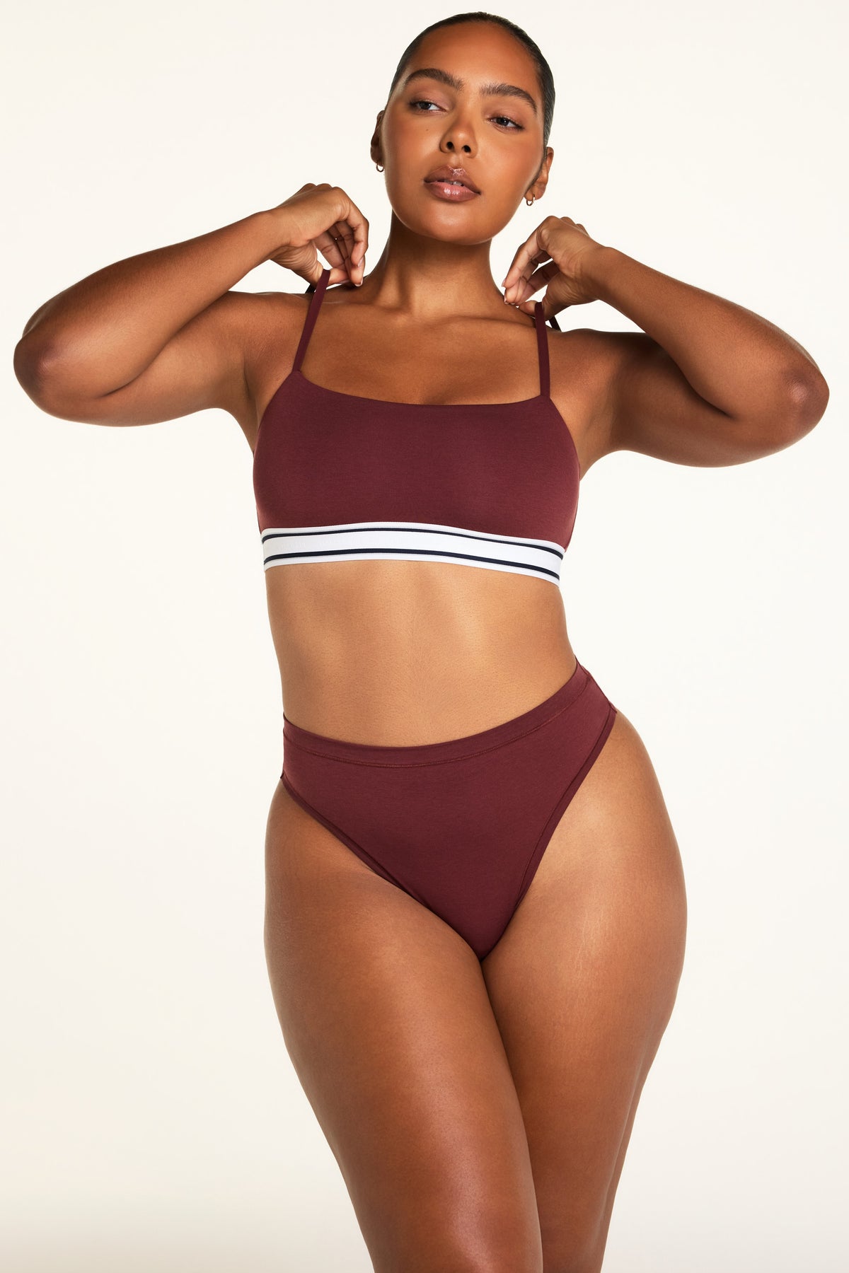 Three-quarter front view of the Cloud Cotton Highwaist Thong in Cabernet paired with the Cloud Cotton Bandeau Bralette in Cabernet.