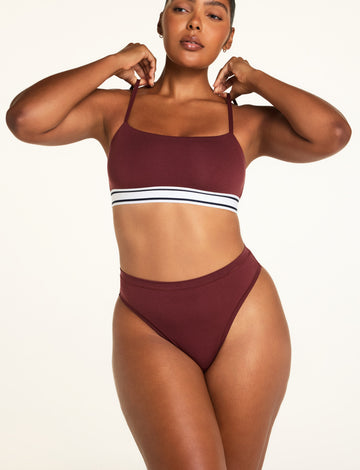 Three-quarter front view of the Cloud Cotton Highwaist Thong in Cabernet paired with the Cloud Cotton Bandeau Bralette in Cabernet.