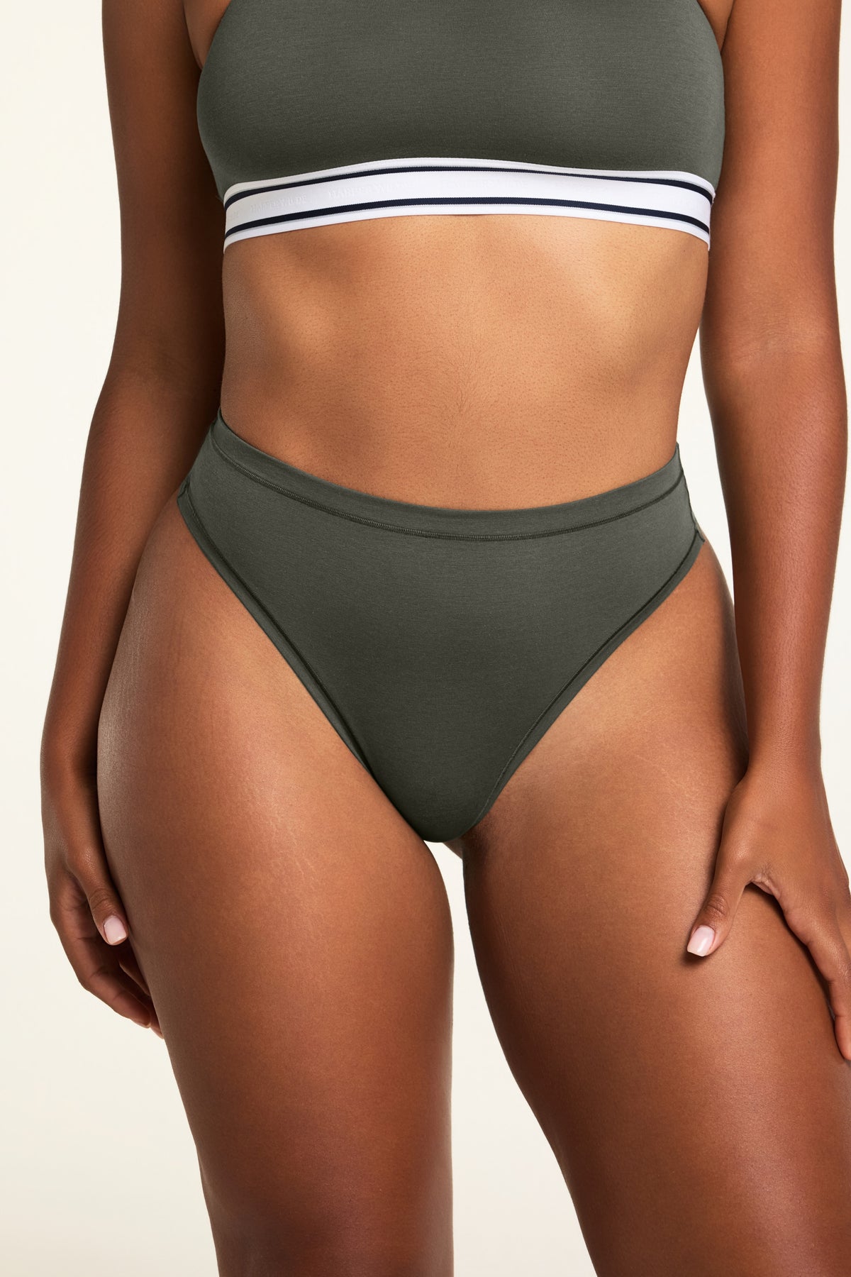 Three-quarter front view of the Cloud Cotton Highwaist Thong in Olive paired with the Cloud Cotton Bandeau Bralette in Olive.