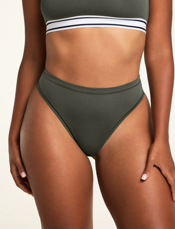 Three-quarter front view of the Cloud Cotton Highwaist Thong in Olive paired with the Cloud Cotton Bandeau Bralette in Olive.