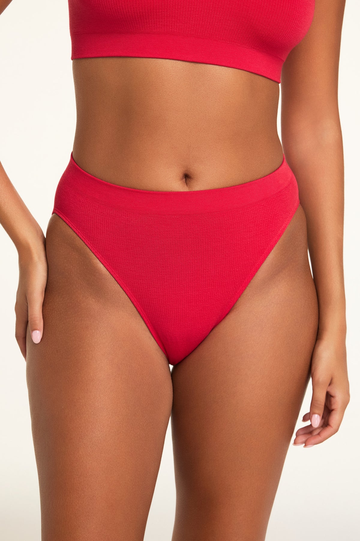 Three-quarter front view of the Knit Seamless French Cut Brief in Cherry paired with the Knit Seamless Bralette in Cherry.