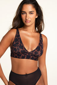 Three-quarter front view of the Bliss Plunge Adjustable Bralette in Bliss Leopard paired with the ComfortMesh™ Brief in Black.