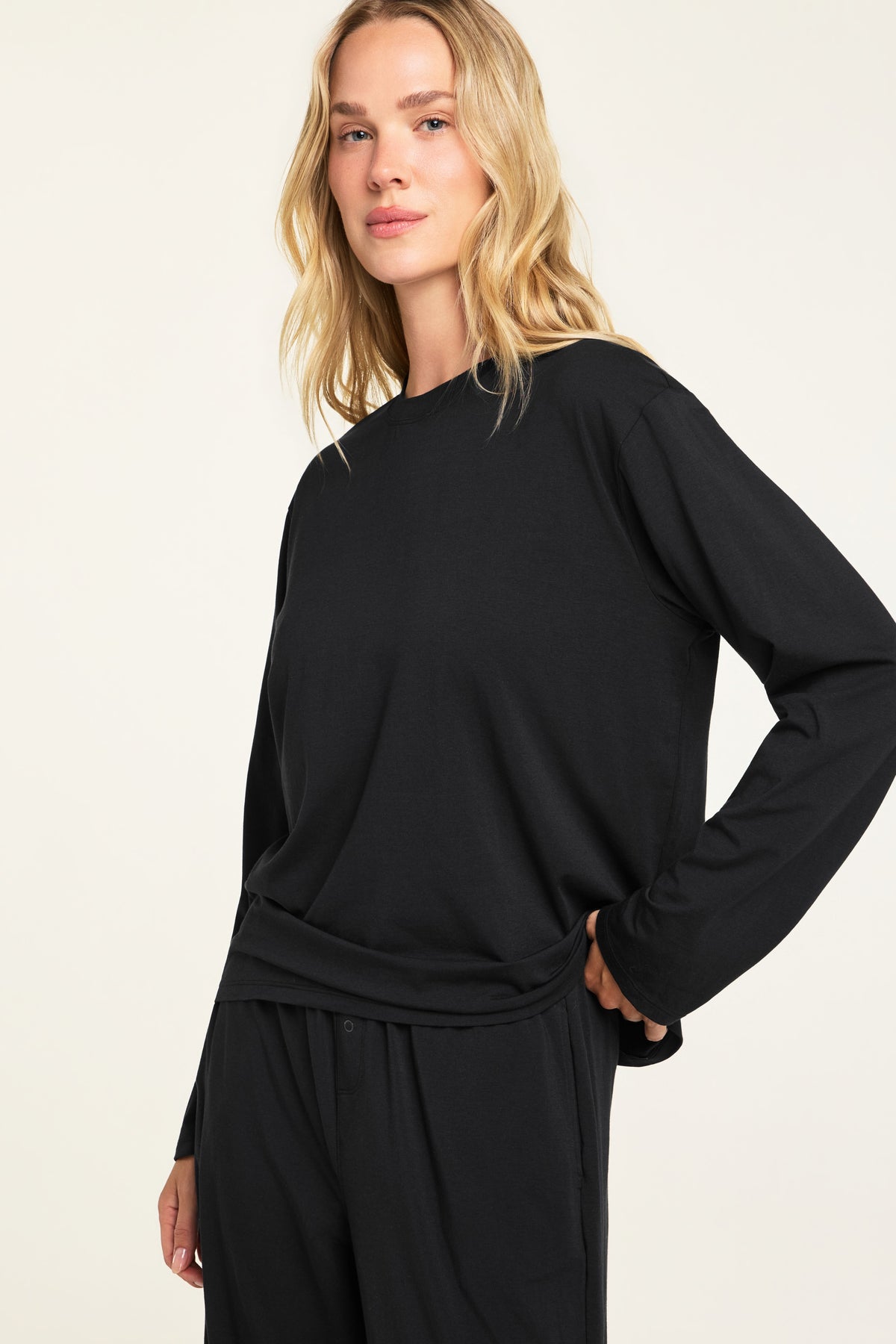 Three-quarter front view of the Cloud Cotton Long Sleeve T-Shirt in Black paired with the Cloud Cotton Pant in Black.