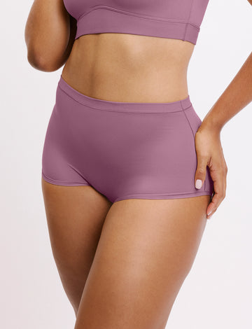 In a studio setting, Amber wears the Bliss Boyshort in Mirage, shown in an angled front view. The design features a mid-rise fit, full coverage, and smooth, seamless fabric. sizing: Amber wears size Large