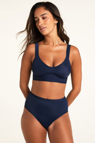 Three-quarter front view of the Bliss Smoothing Bralette in Navy, highlighting the wide straps and smooth wireless cup construction