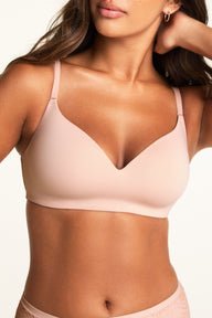 Three-quarter front view of the Bliss Wirefree Bra in Ember Rose, showing the adjustable strap hardware and smooth cup edge