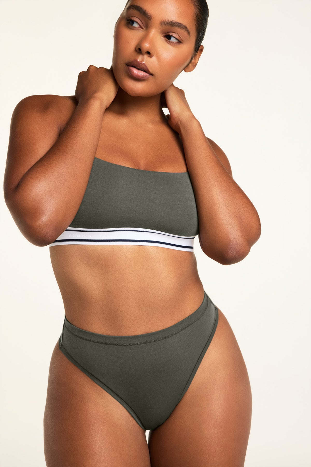 Back on-model view of the Cloud Cotton Highwaist Thong in Olive paired with the Cloud Cotton Bandeau Bralette in Olive.