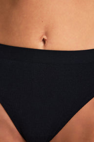 Back on-model view of the Knit Seamless French Cut Brief in Black paired with the Knit Seamless Bralette in Bralette.
