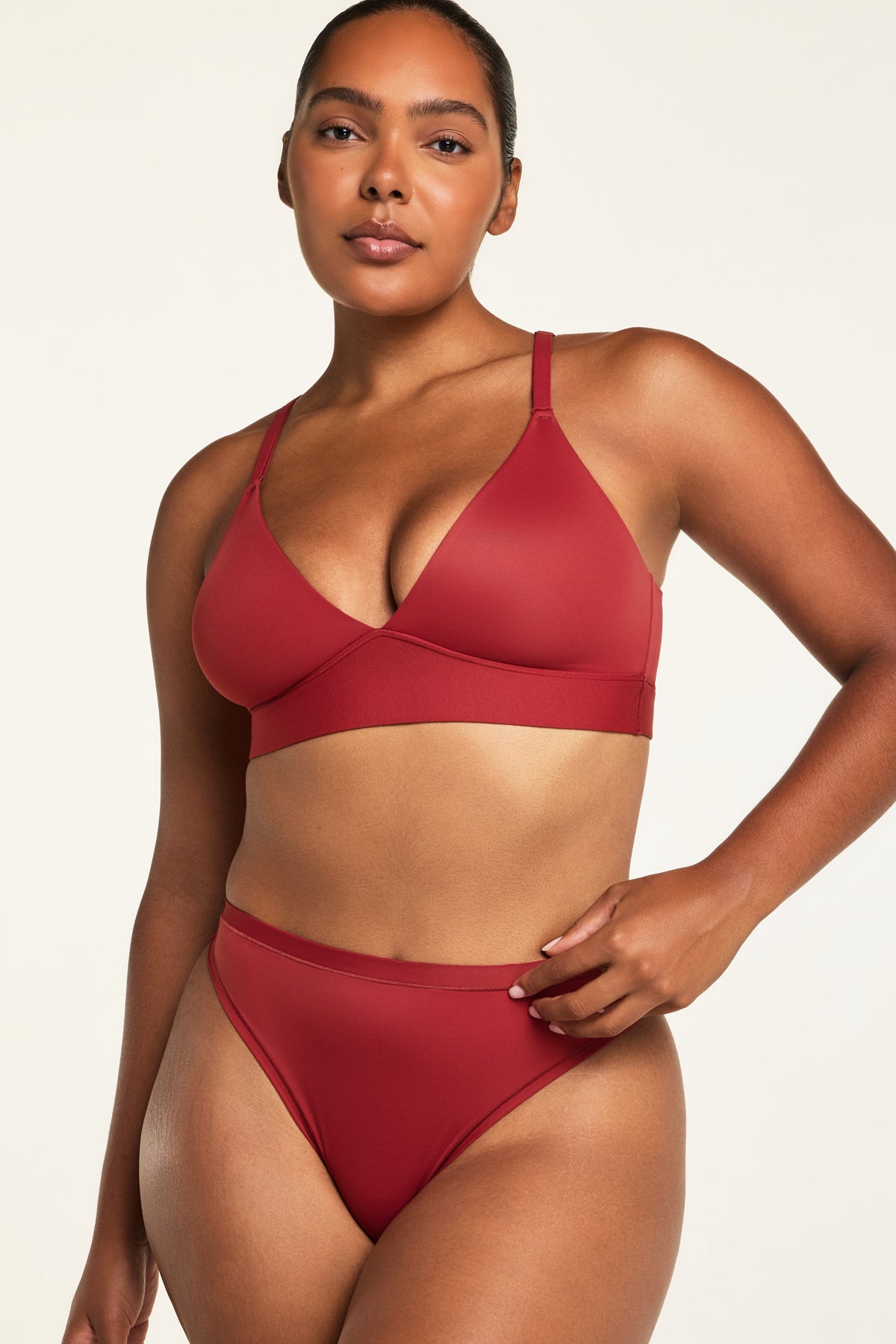 Back on-model view of the Bliss Triangle Bralette in Ruby paired with the Bliss Thong in Ruby.