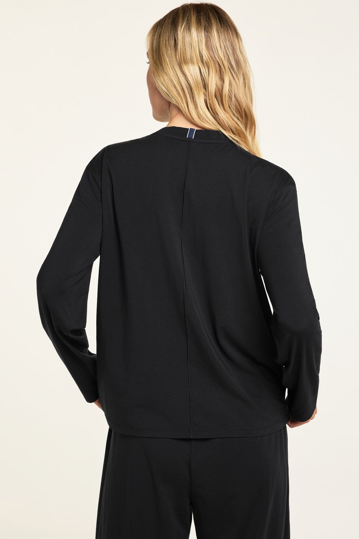 Back on-model view of the Cloud Cotton Long Sleeve T-Shirt in Black paired with the Cloud Cotton Pant in Black.