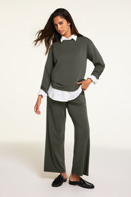 On-model product shot of the Cloud Cotton Long Sleeve T-Shirt in Olive paired with the Cloud Cotton Pant in Olive.
