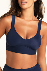 Side view of the Bliss Smoothing Bralette in Navy, showing the smooth wireless profile and wide supportive band silhouette