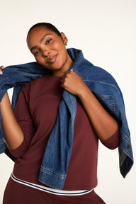 Editorial on-model shot of the Cloud Cotton Long Sleeve T-Shirt in Cabernet styled with the Cloud Cotton Pant in Cabernet.