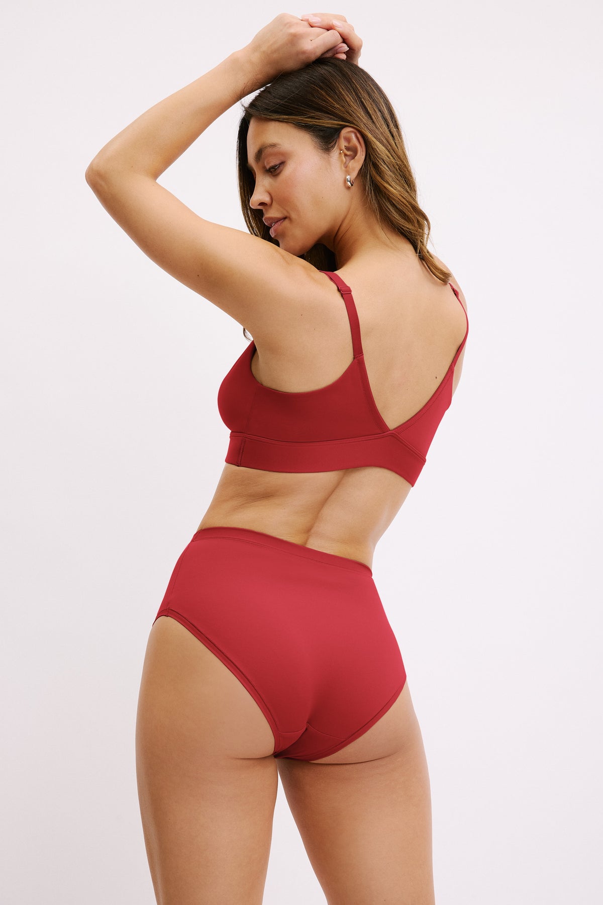 Three-quarter back view of the Bliss Highwaist Brief in Ruby paired with the Bliss Triangle Bralette in Ruby.