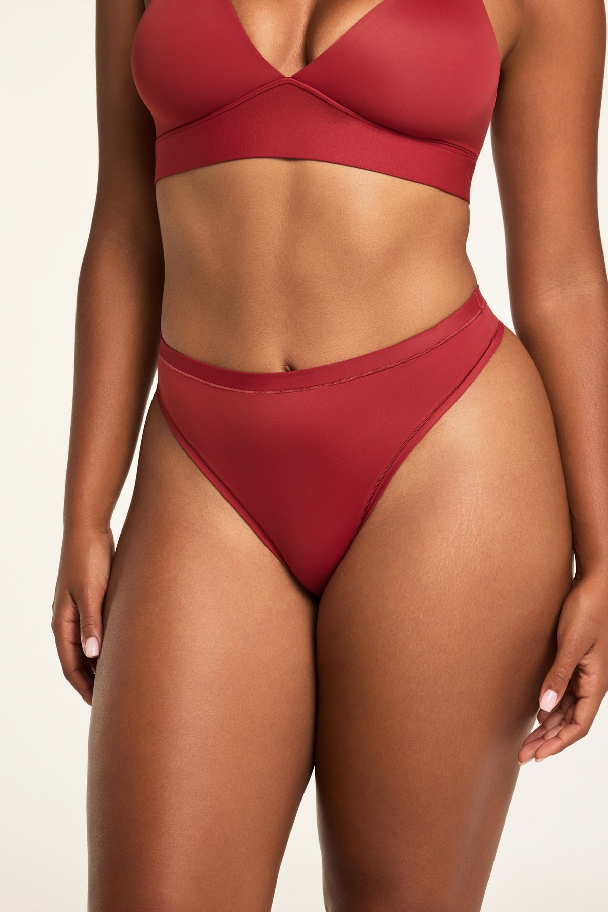 Close-up front view of the Bliss Thong in Ruby paired with the Bliss Triangle Bralette in Ruby.