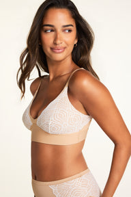 Three-quarter front view of model wearing the Bliss Lace Highwaist Brief in Beige with white geometric fan lace side panels and smooth beige front panel, paired with the Bliss Lace Bralette in Beige featuring white lace cups and a smooth beige underband