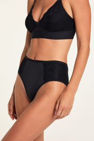 Close-up of Holly wearing the Bliss Lace Bralette and Bliss Lace Highwaist Brief in Black, highlighting the lace trim and soft microfiber fabric.