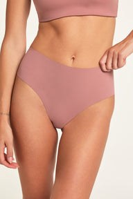 Close-up front view of Holly wearing the No-Show Highwaist Thong in Plum, with the waistband pulled slightly to show its stretch.