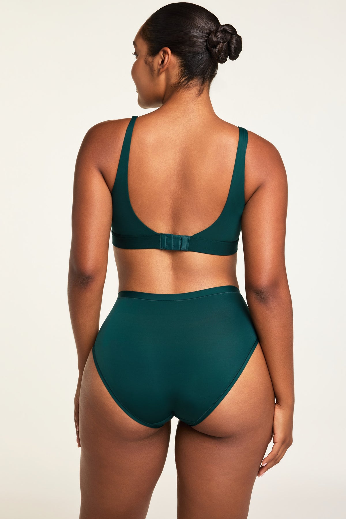 Side on-model view of the Bliss French Cut Brief in Pine paired with the Bliss Scoop Bralette in Pine.