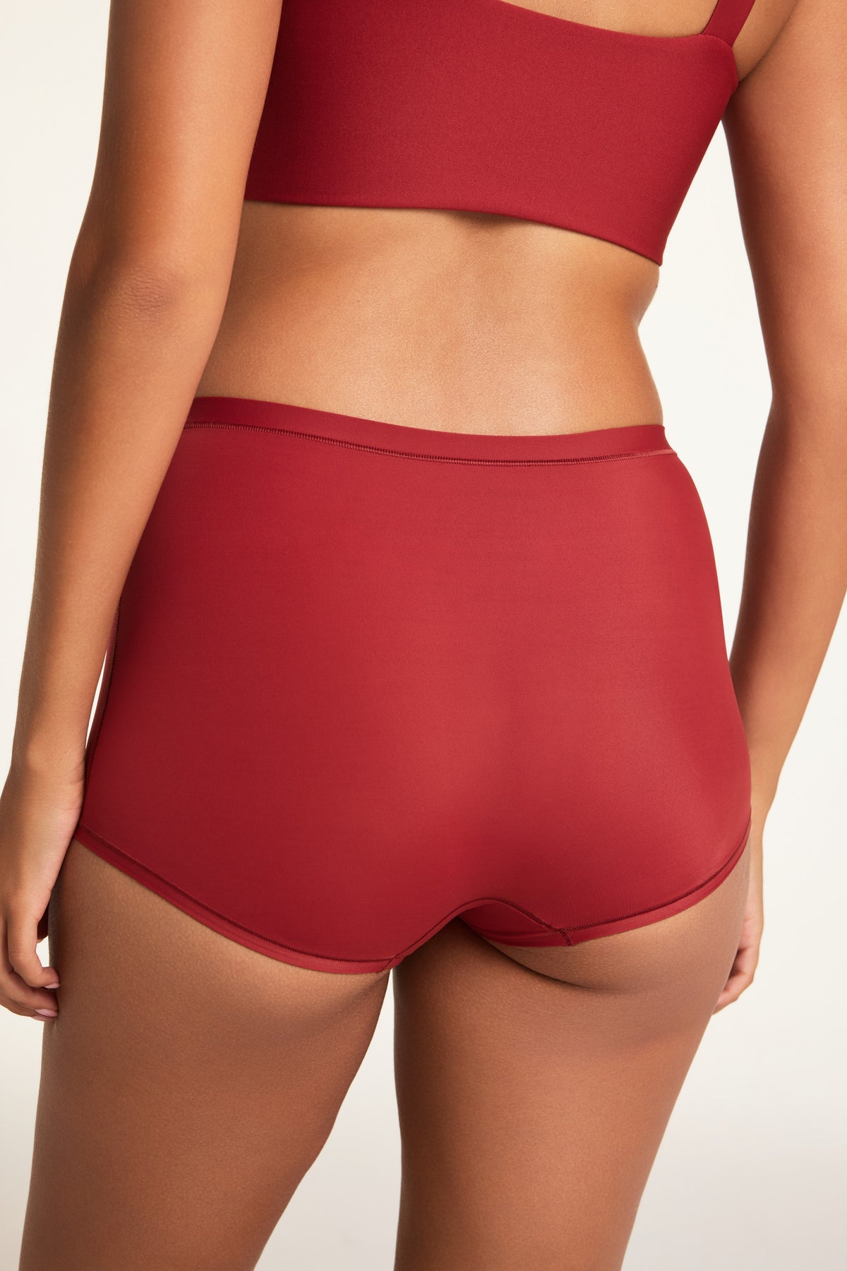 Side on-model view of the Bliss Boyshort in Ruby paired with the BlissSmooth Bralette in Ruby.