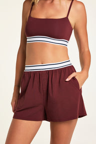Side on-model view of the Cloud Cotton Short in Cabernet paired with the Cloud Cotton T-Shirt in Cabernet.