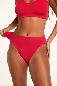 Side on-model view of the Knit Seamless French Cut Brief in Cherry paired with the Knit Seamless Bralette in Cherry.