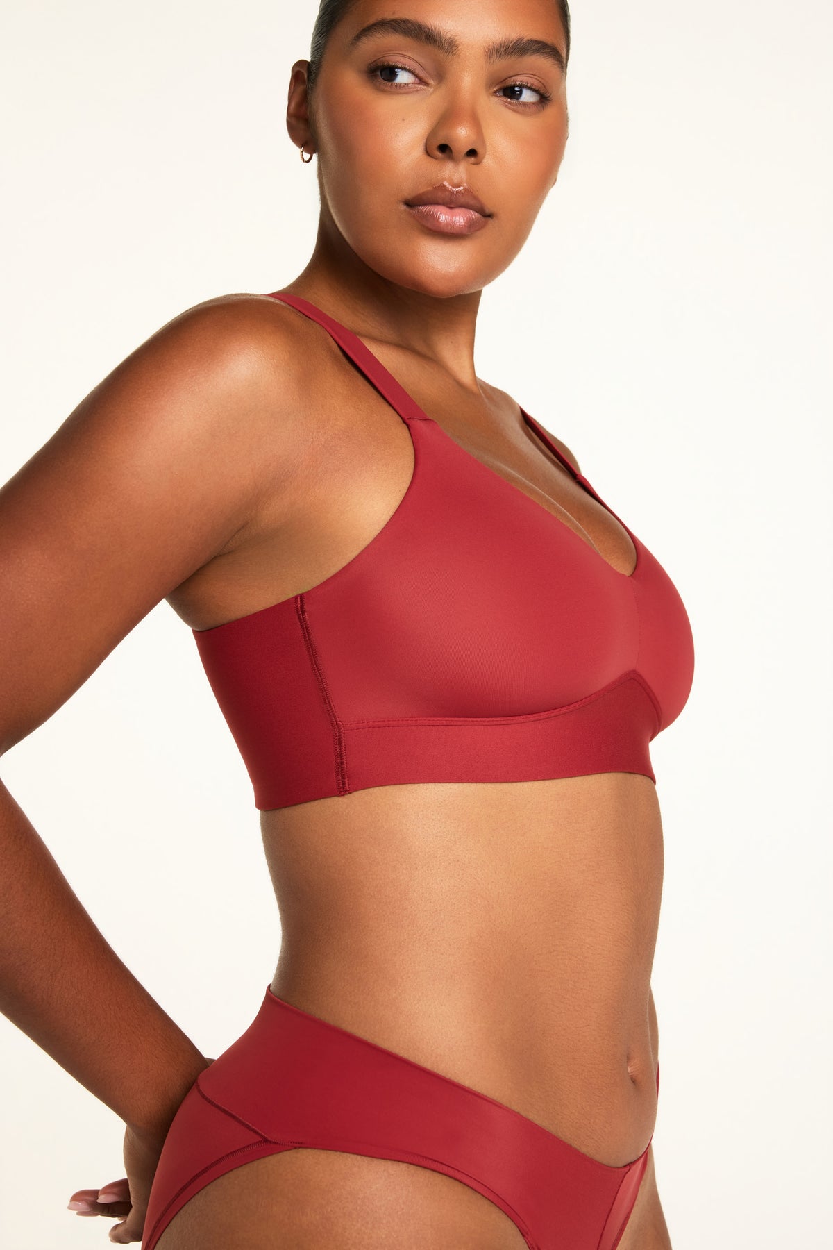 Side on-model view of the BlissSmooth Bralette in Ruby paired with the Bliss Low Rise Bikini in Ruby.