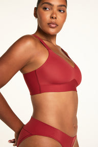Side on-model view of the BlissSmooth Bralette in Ruby paired with the Bliss Low Rise Bikini in Ruby.