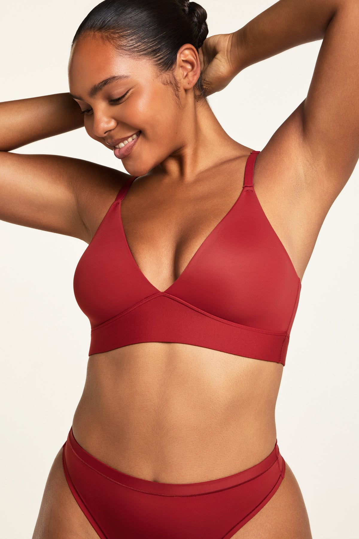 Side on-model view of the Bliss Triangle Bralette in Ruby paired with the Bliss Thong in Ruby.
