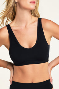Side on-model view of the Knit Seamless Bralette in Black paired with the Knit Seamless French Cut Brief in Black.