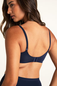Back view of the Base Balconette in Navy, showing the hook-and-eye closure, back band, and thin adjustable straps