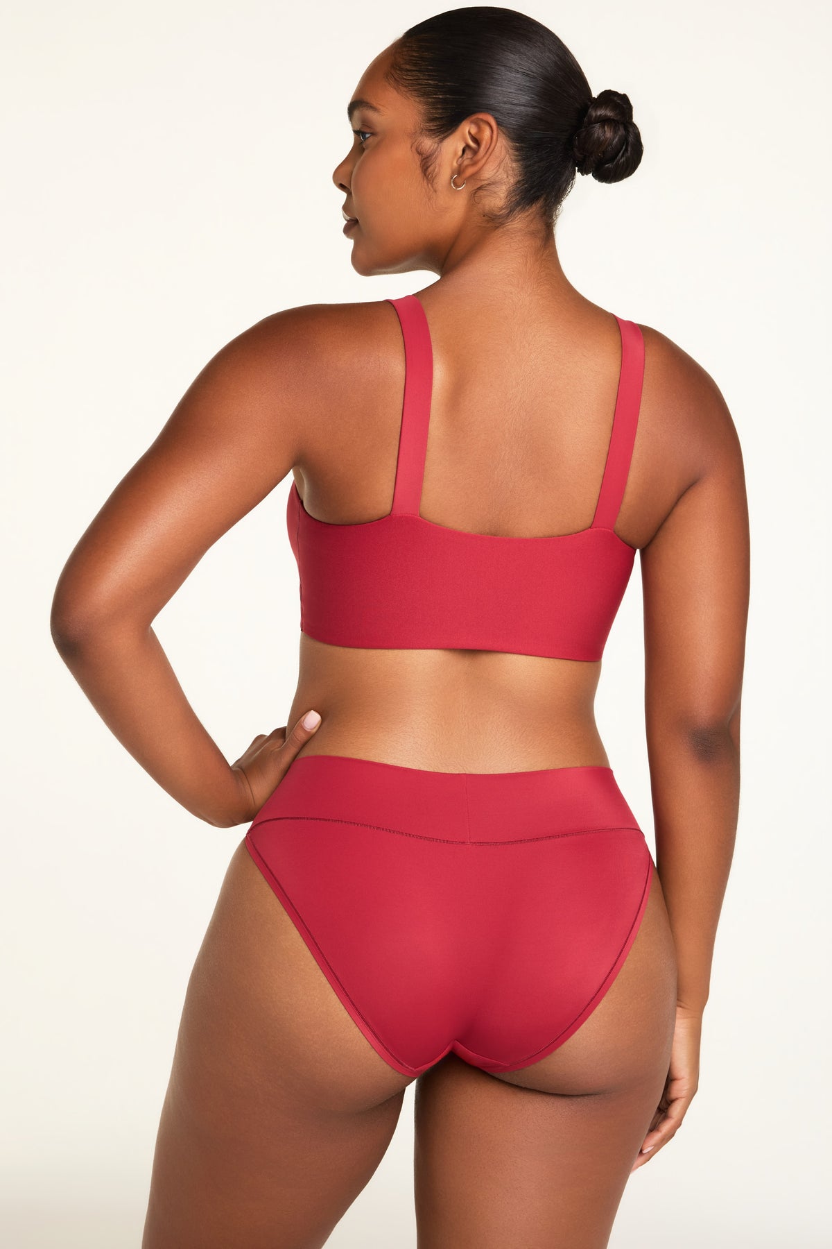 Three-quarter back view of the Bliss Low Rise Bikini in Ruby paired with the BlissSmooth Bralette in Ruby.
