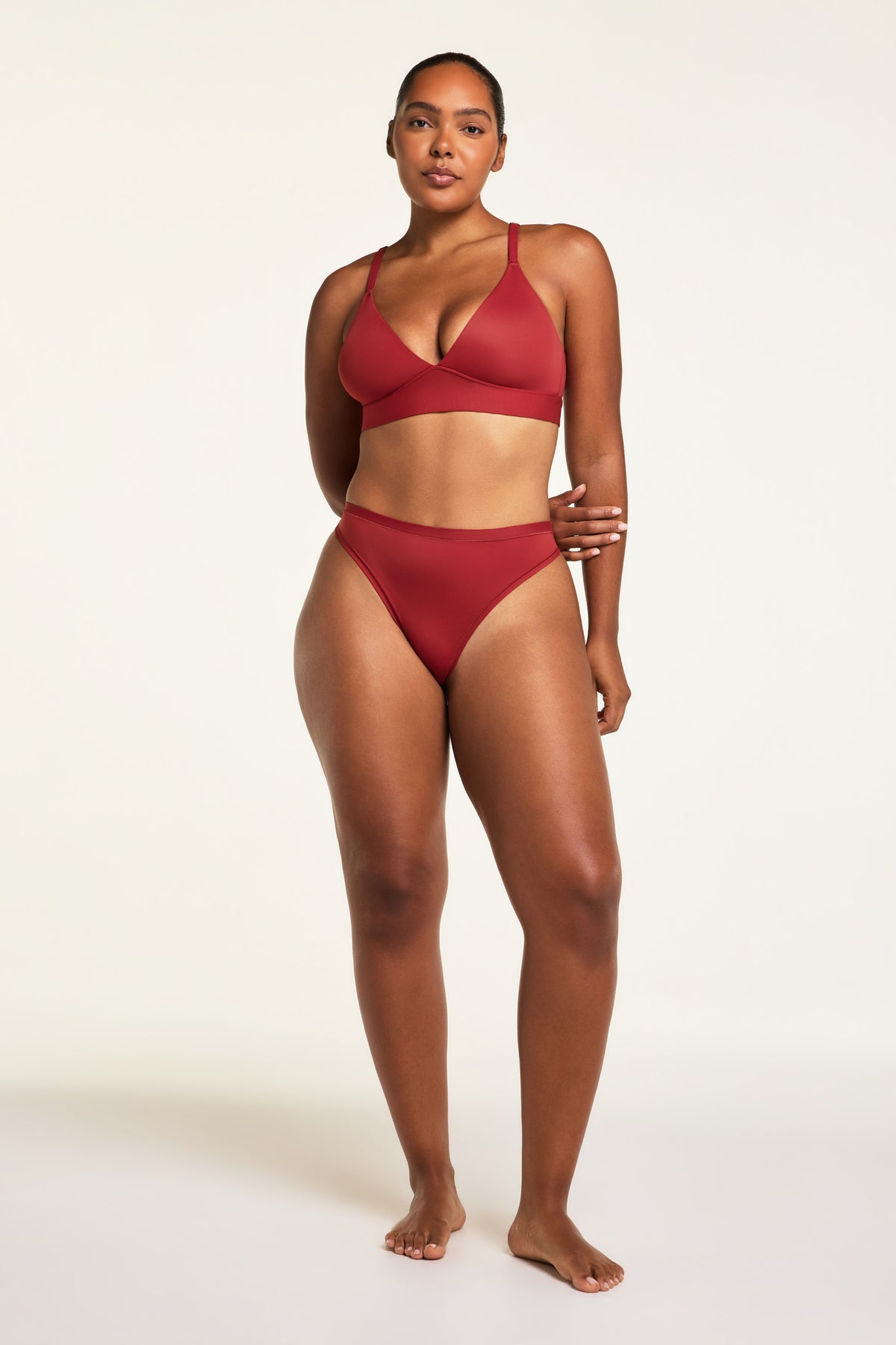 Three-quarter back view of the Bliss Thong in Ruby paired with the Bliss Triangle Bralette in Ruby.