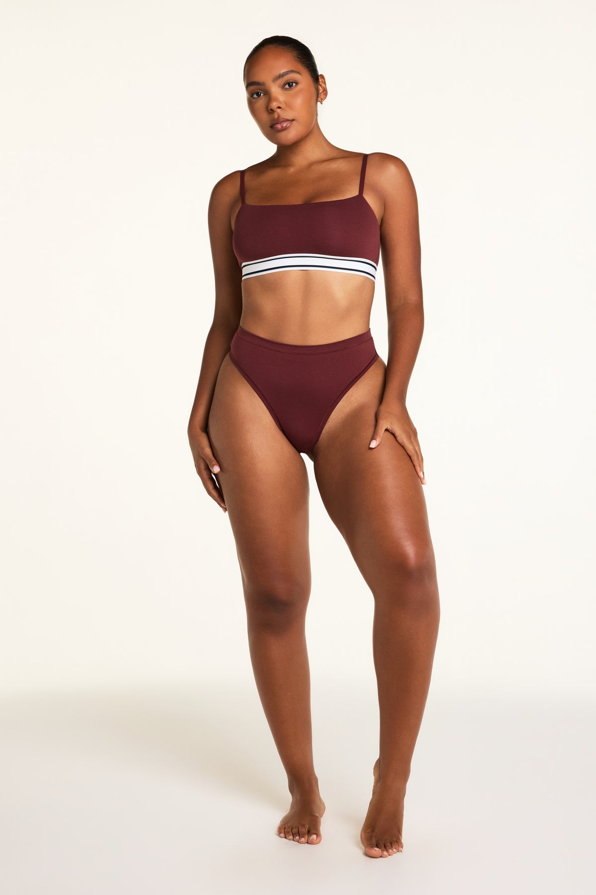 Three-quarter back view of the Cloud Cotton Highwaist Thong in Cabernet paired with the Cloud Cotton Bandeau Bralette in Cabernet.