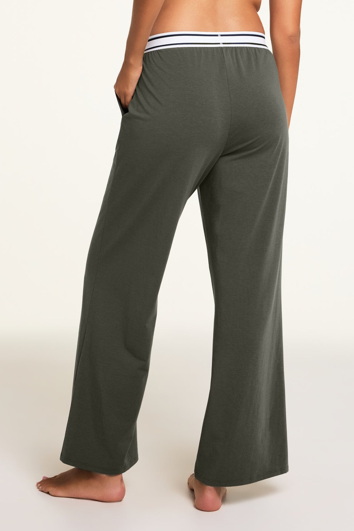 Three-quarter back view of the Cloud Cotton Pant in Olive paired with the Cloud Cotton Bandeau Bralette in Olive.