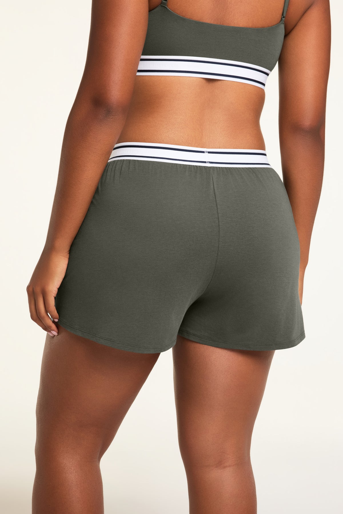 Three-quarter back view of the Cloud Cotton Short in Olive paired with the Cloud Cotton Bandeau Bralette in Olive.