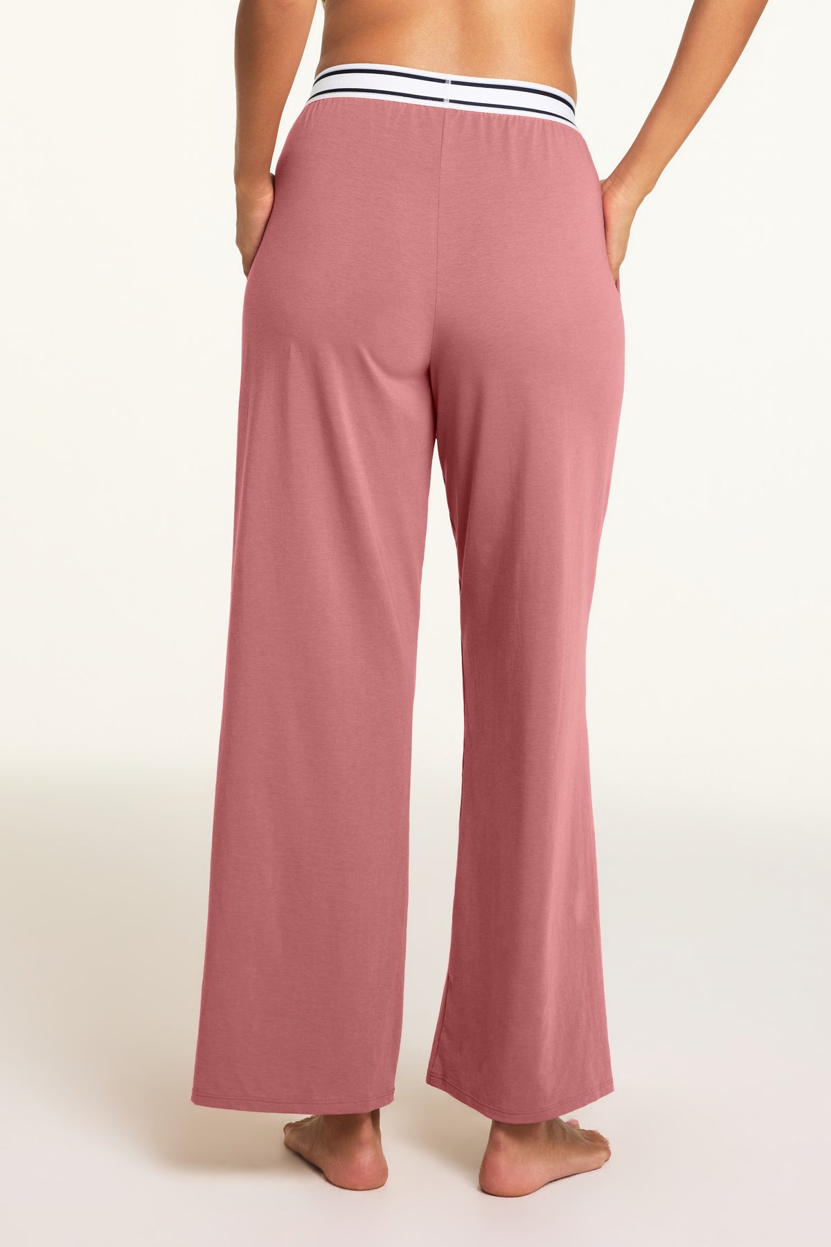 Three-quarter back view of the Cloud Cotton Pant in Winter Rose paired with the Cloud Cotton Bandeau Bralette in Winter Rose.