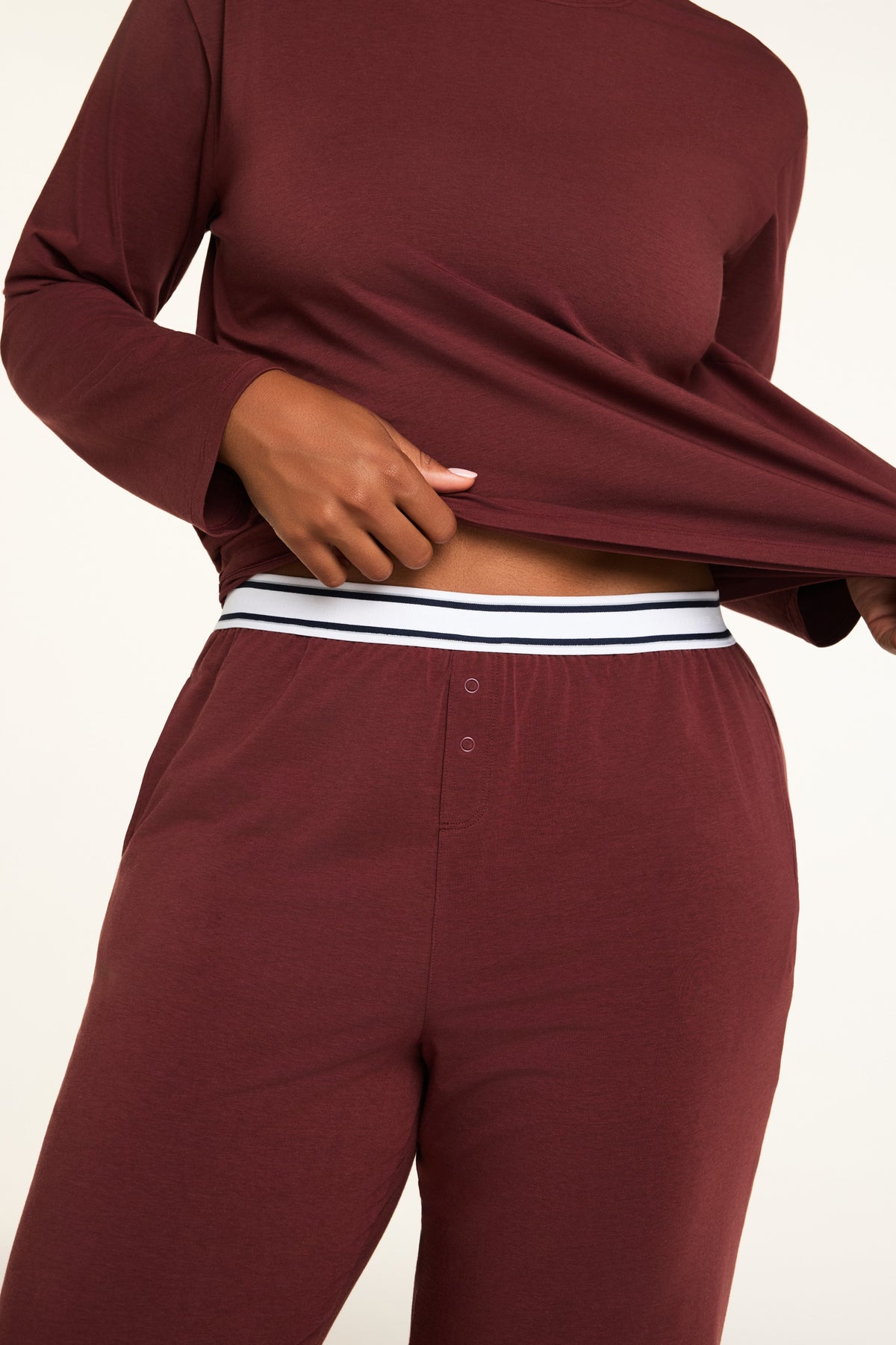 Three-quarter back view of the Cloud Cotton Pant in Cabernet paired with the Cloud Cotton Long Sleeve T-Shirt in Cabernet.