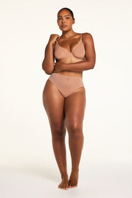Three-quarter back view of the ComfortMesh™ Highwaist Brief in Taupe paired with the ComfortMesh™ Plunge Bra in Taupe.
