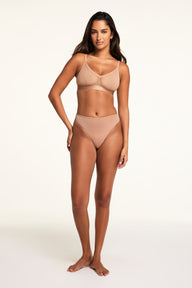 Three-quarter back view of the ComfortMesh™ Thong in Taupe paired with the ComfortMesh™ Triangle Bralette in Taupe.