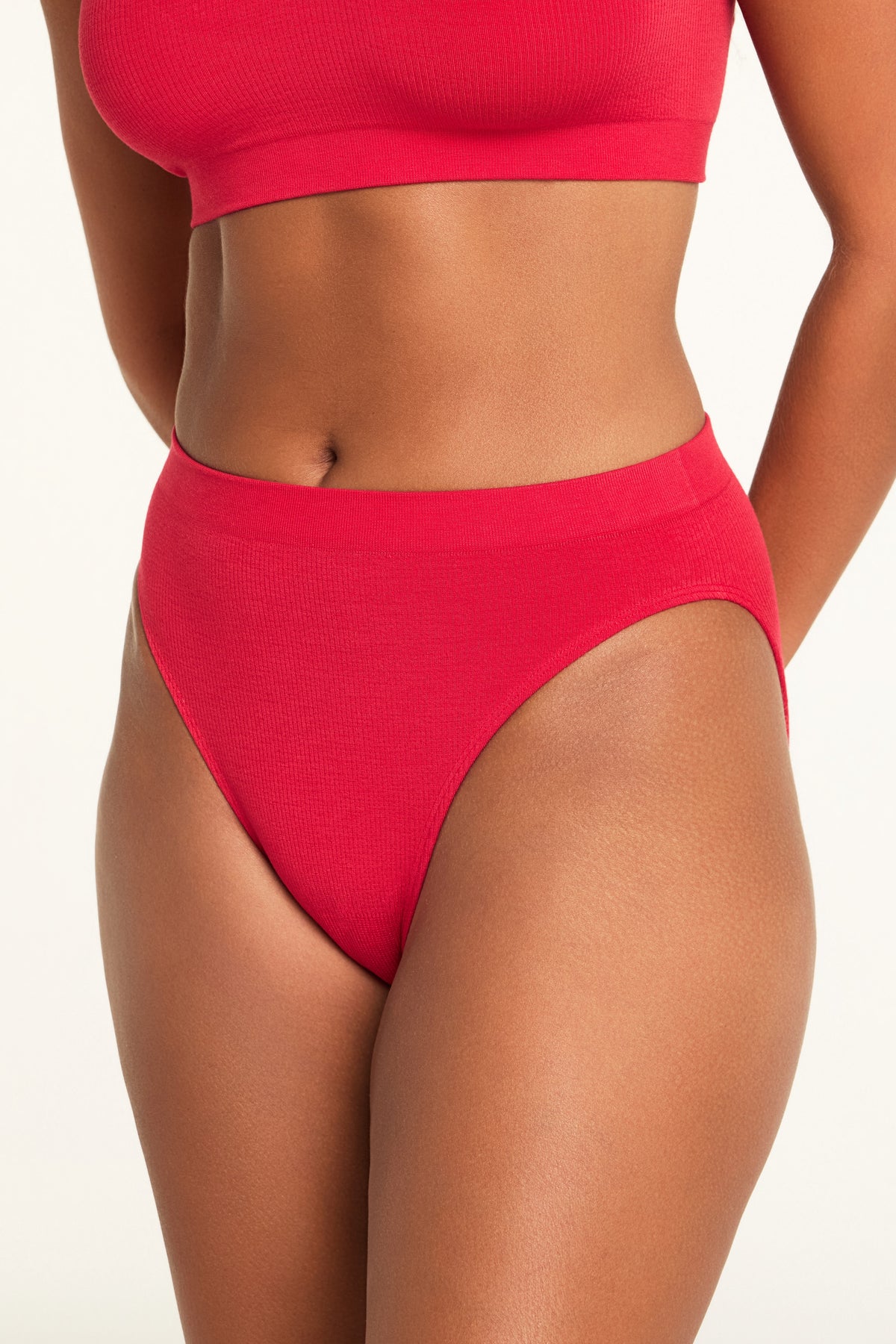 Three-quarter back view of the Knit Seamless French Cut Brief in Cherry paired with the Knit Seamless Bralette in Cherry.