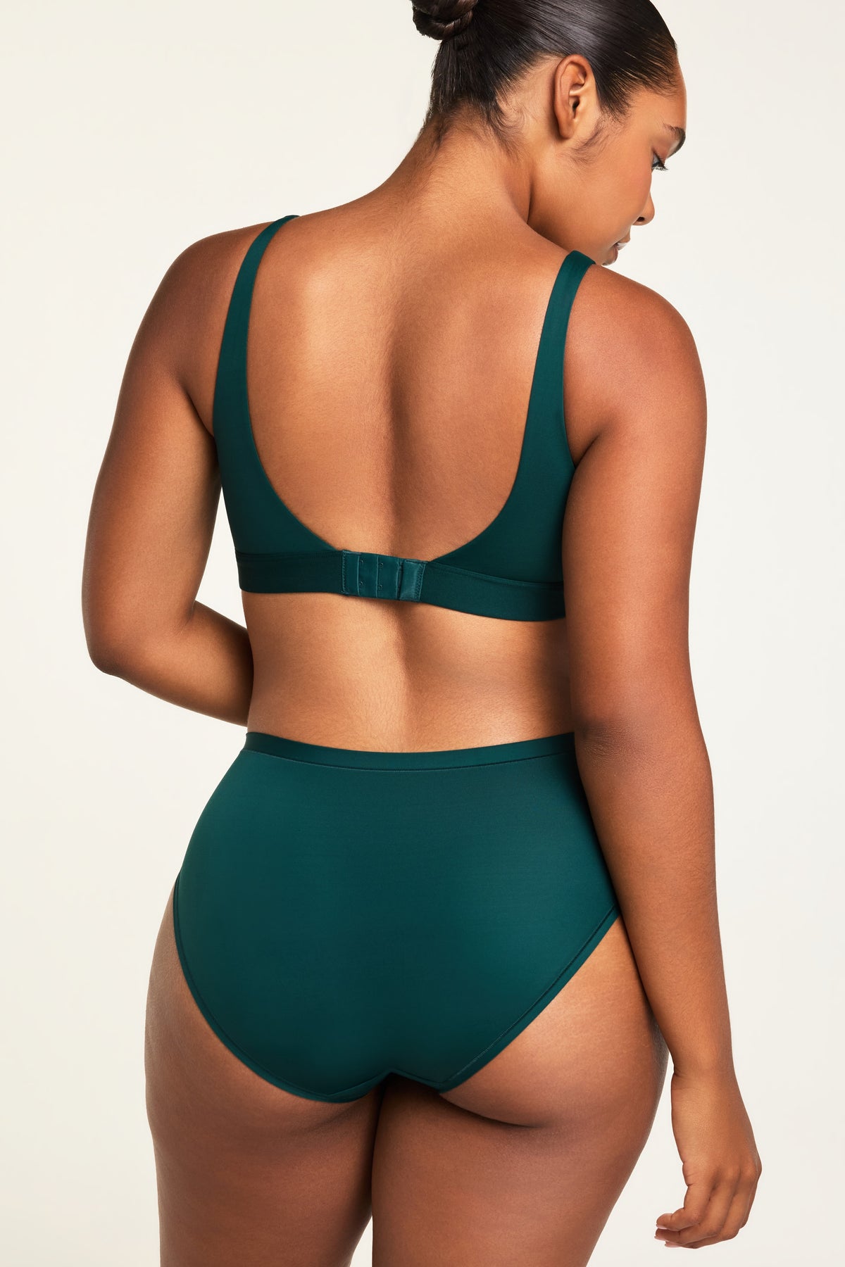 Three-quarter back view of the Bliss Scoop Bralette in Pine paired with the Bliss French Cut Brief in Pine.