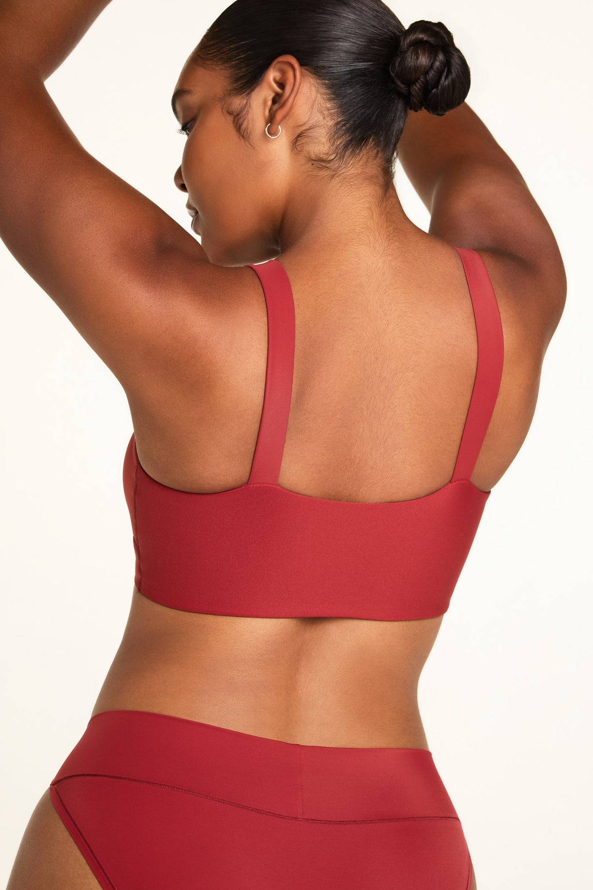 Three-quarter back view of the BlissSmooth Bralette in Ruby paired with the Bliss Low Rise Bikini in Ruby.