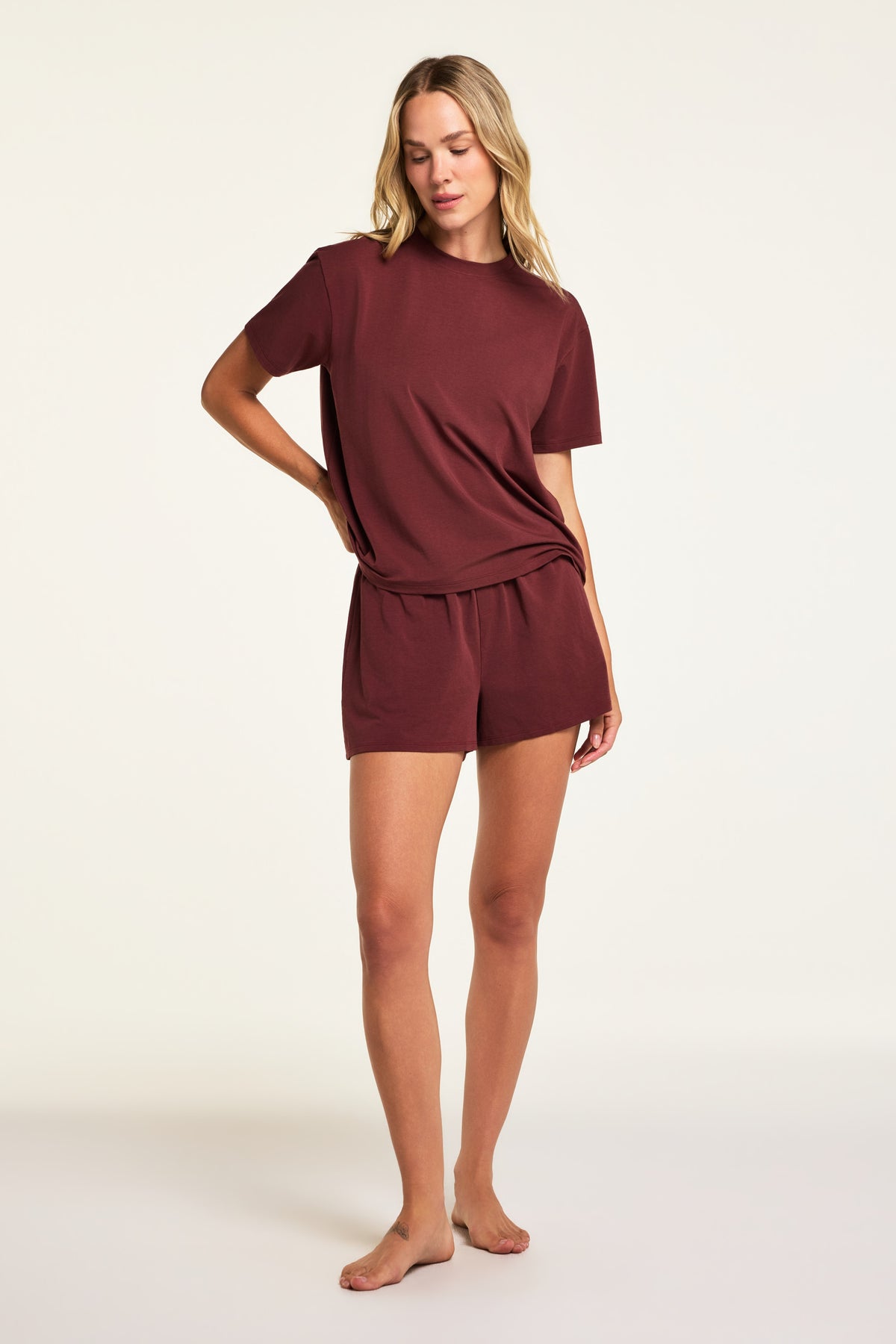 Three-quarter back view of the Cloud Cotton T-Shirt in Cabernet paired with the Cloud Cotton Short in Cabernet.