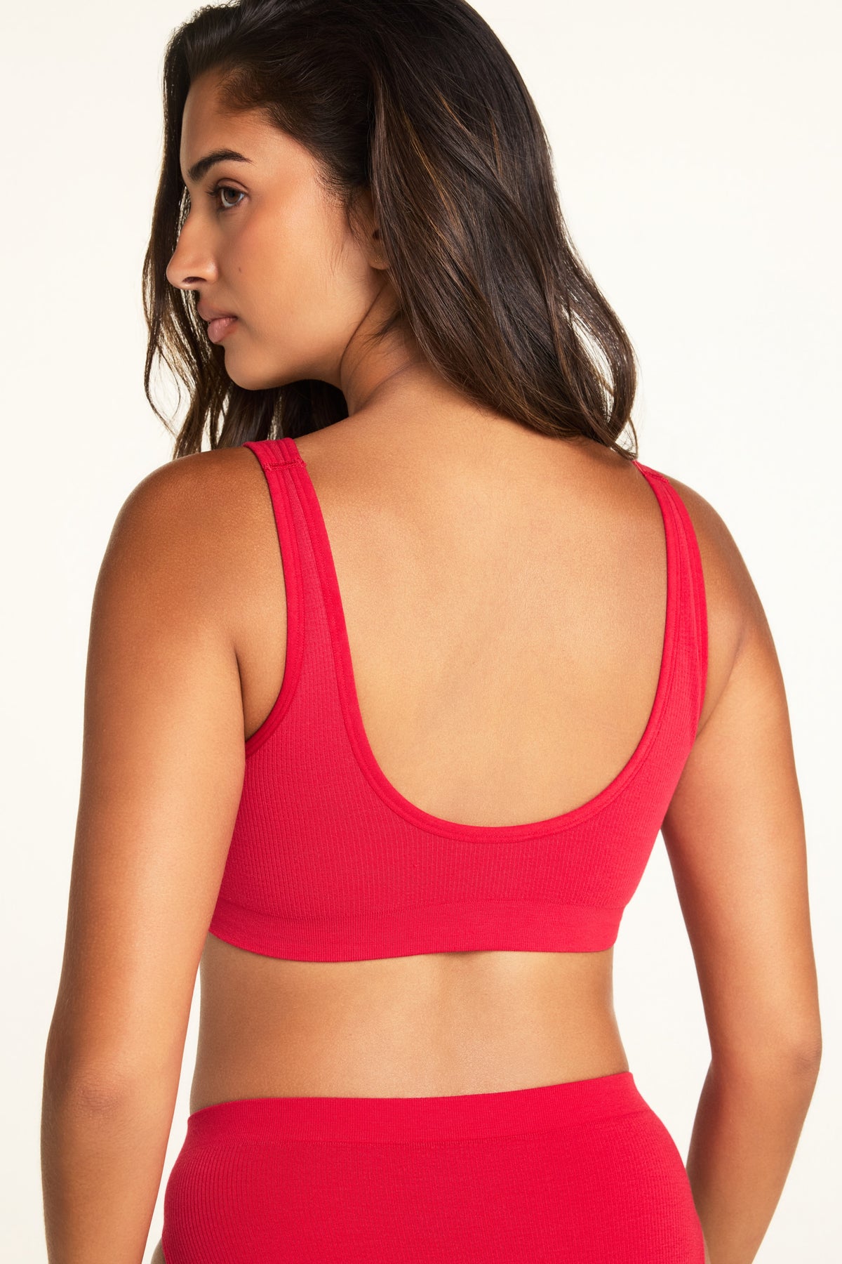 Three-quarter back view of the Knit Seamless Bralette in Cherry paired with the Knit Seamless French Cut Brief in Cherry.